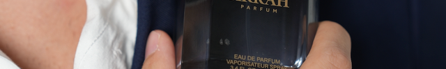 grey bottle of Arrah parfum oud fragrance on the shoulder of a man